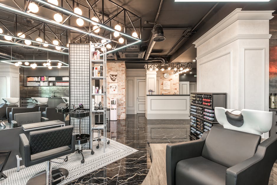 Backwash chair with sink placed near shelves with cosmetology products and reception desk in stylish beauty salon with decorated walls